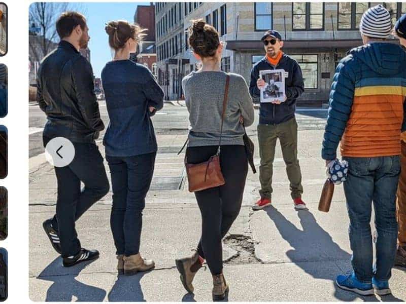 A group of people listening to a tour guide during a Women's History tour in Portland, Maine.